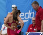 swimsuit malfunction...Is there<br />a tailor in the arena??????<br />looks like the coaches are having fun/<br />a laugh with that issue