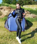 camping in leder<br />unusual to see someone wearing leder <br />and a camping tent in the woods with a<br />glass drink in hand; very unusual indeed