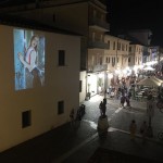 Night photographic projection on the buildings of the city centre of Follonica, Tuscany, Italy.
